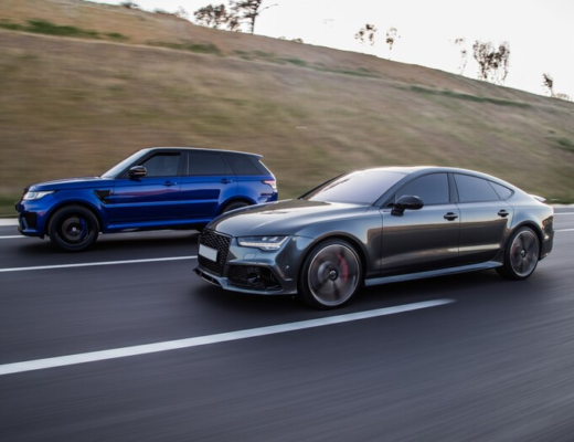 Auto Racing a Blue Jeep and a Gray Sedan