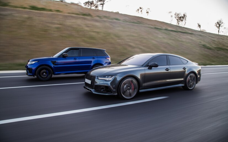 Auto Racing a Blue Jeep and a Gray Sedan