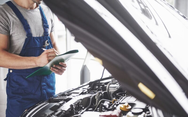 Man checking car engine