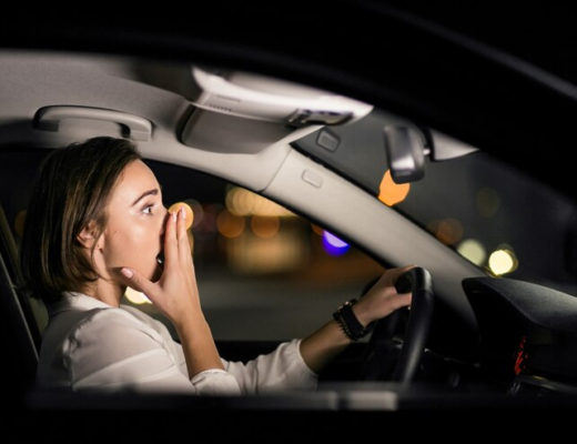 Woman Cover her Mouth in Car