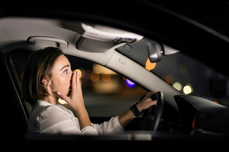 Woman Cover her Mouth in Car