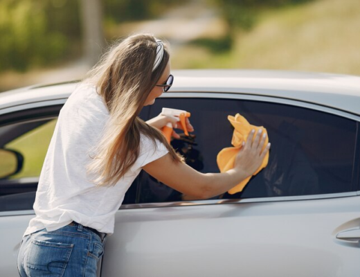 Woman Wipes the Car with a Rag