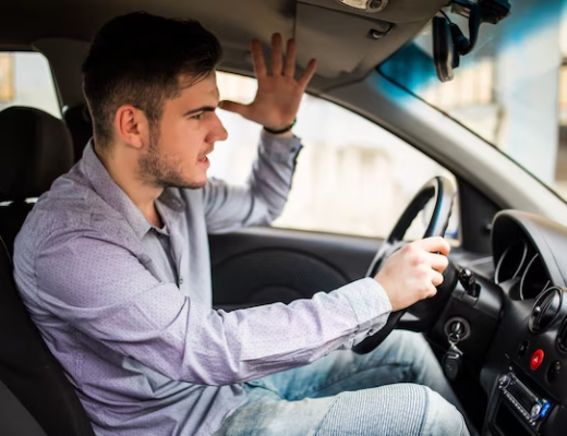 A man sitting angry in a car