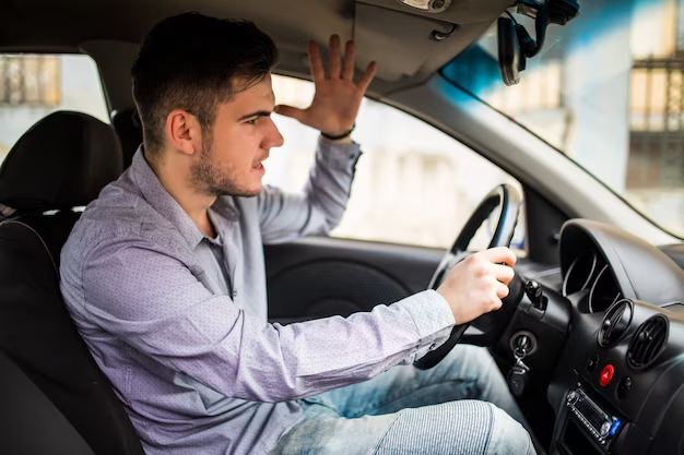 A man sitting angry in a car