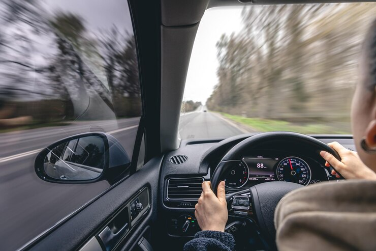 Woman Drivers Hands on a Car Steering Wheel